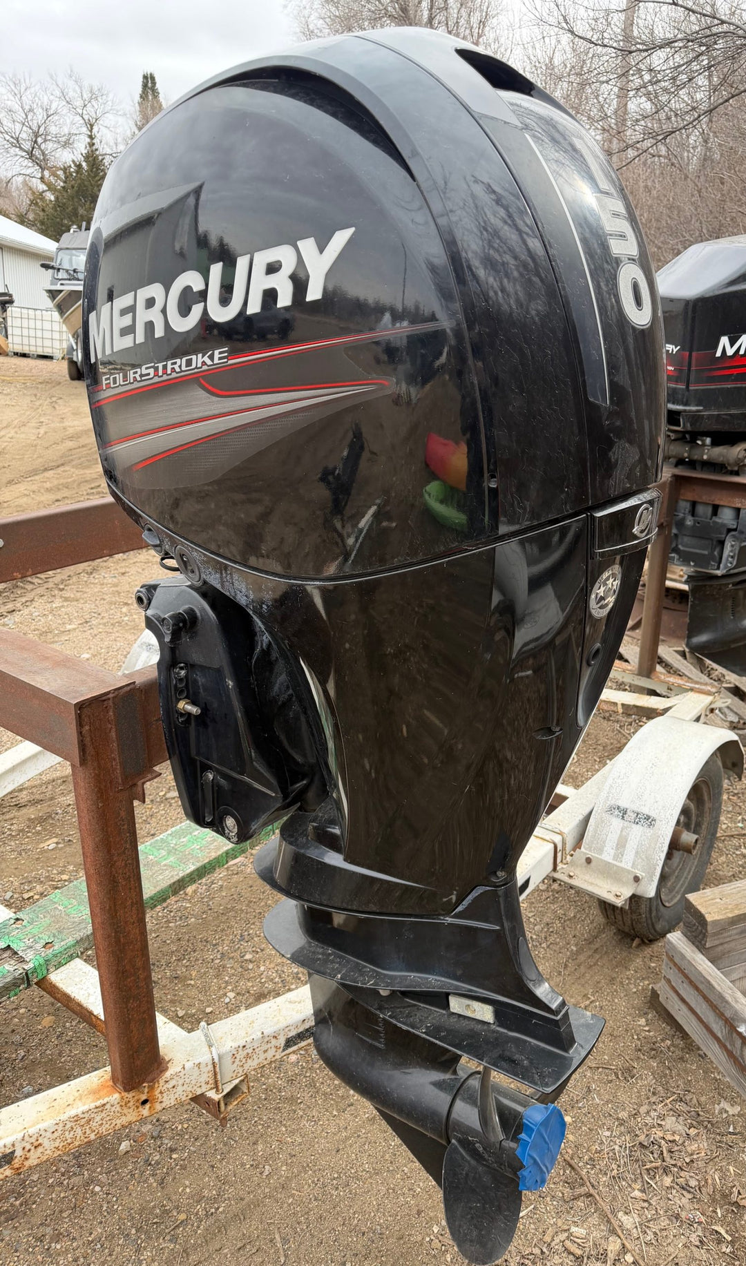Black 150 horsepower Mercuery outboard motor on a stand