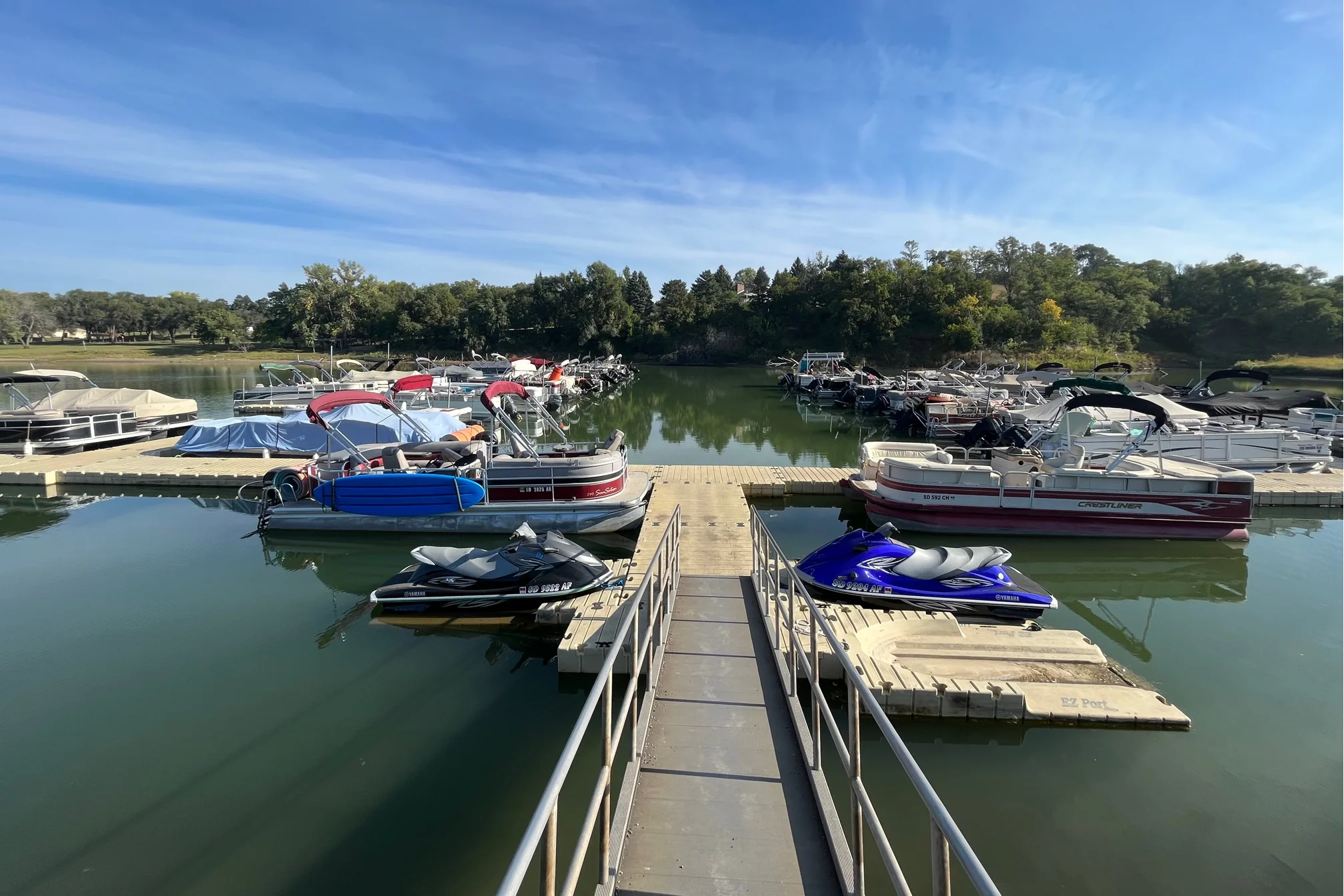 Marina with boats and jet skis on a clear day